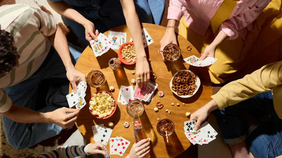 Adult friends playing a table game at a party