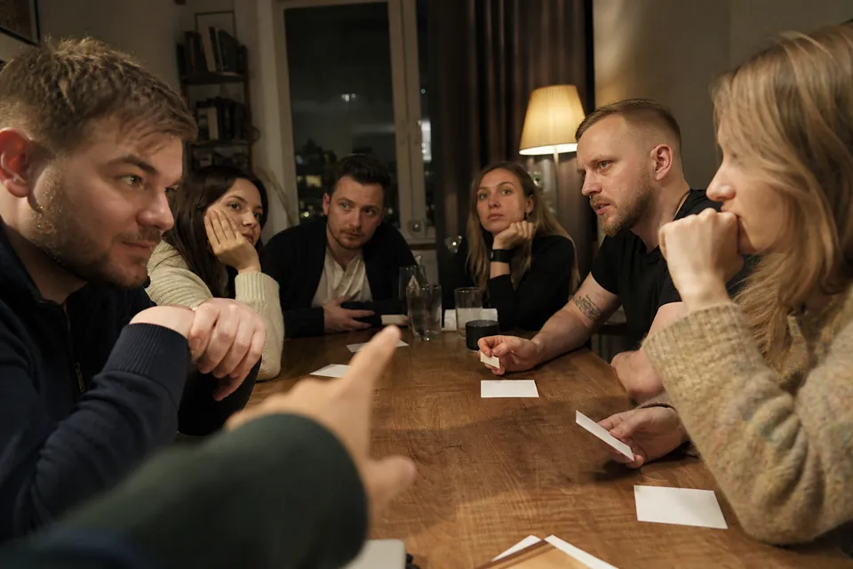 A group comparing clues before voting for the impostor