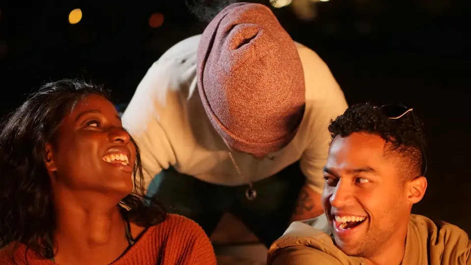 Friends laughing together during a casual game