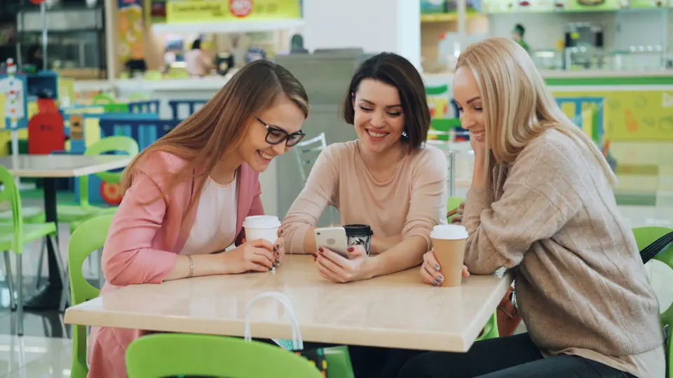 Three friends chatting at a café
